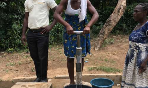 A villager pumping clean water