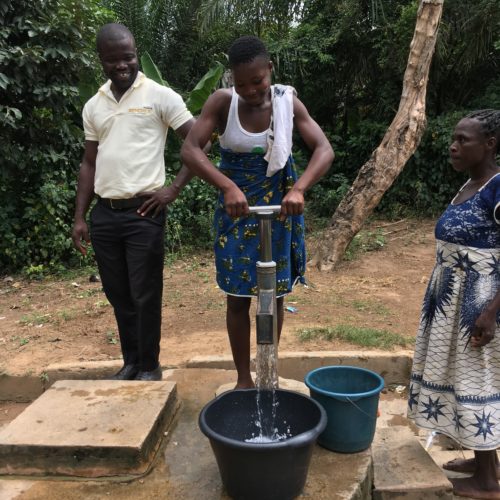 A villager pumping clean water